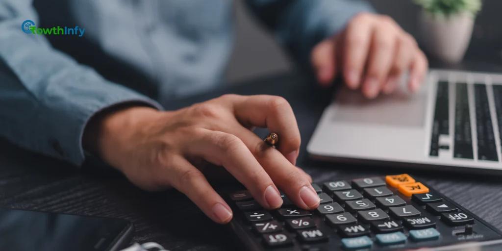 A calculator and financial documents on a desk, representing advance tax calculation.